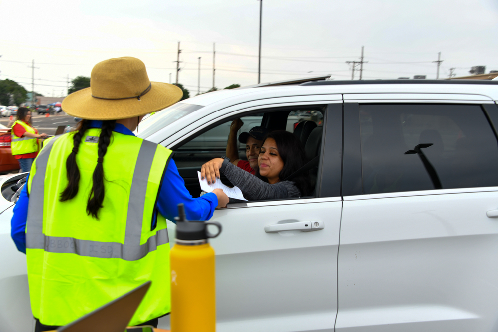 Lubbock ISD employee assisting family during drive-thru registration